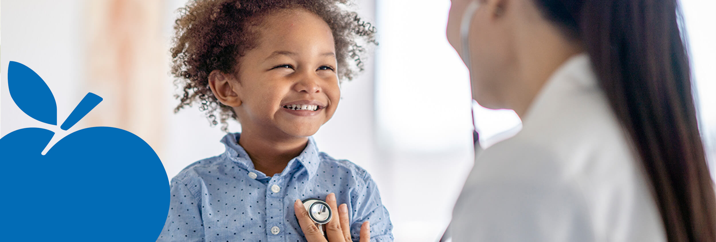 2025 Apple Bank Header Photos Doctor checking heartbeat of toddler.