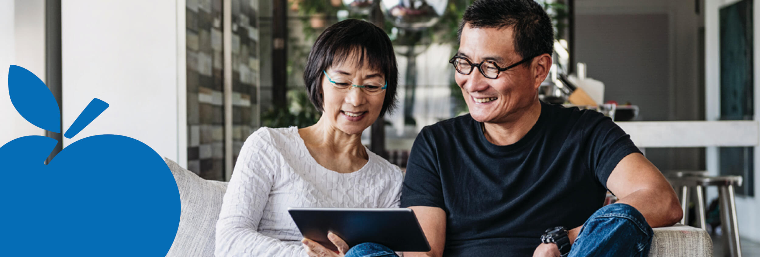 2025 Apple Bank Header Photos17 Couple on sofa reading laptop.