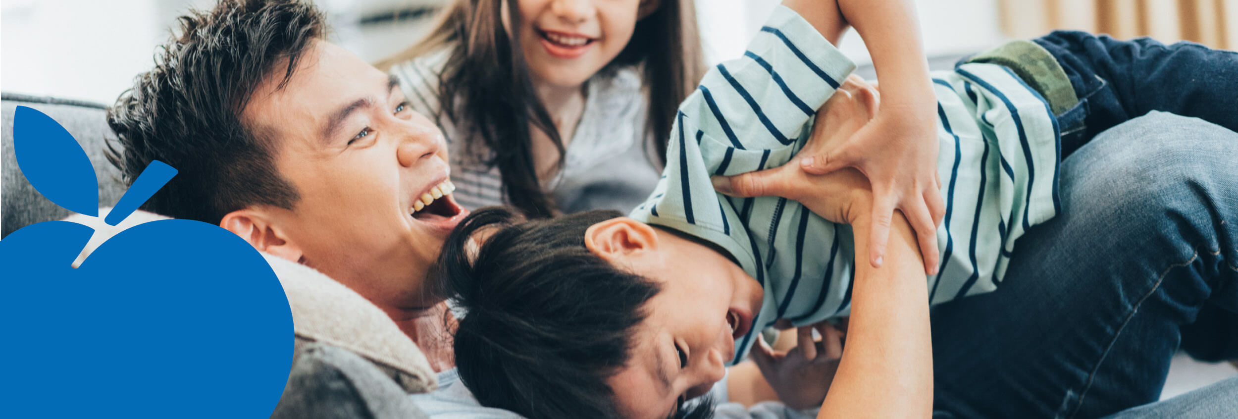 2025 Apple Bank Header Photos4 Dad playing with his kids on sofa.
