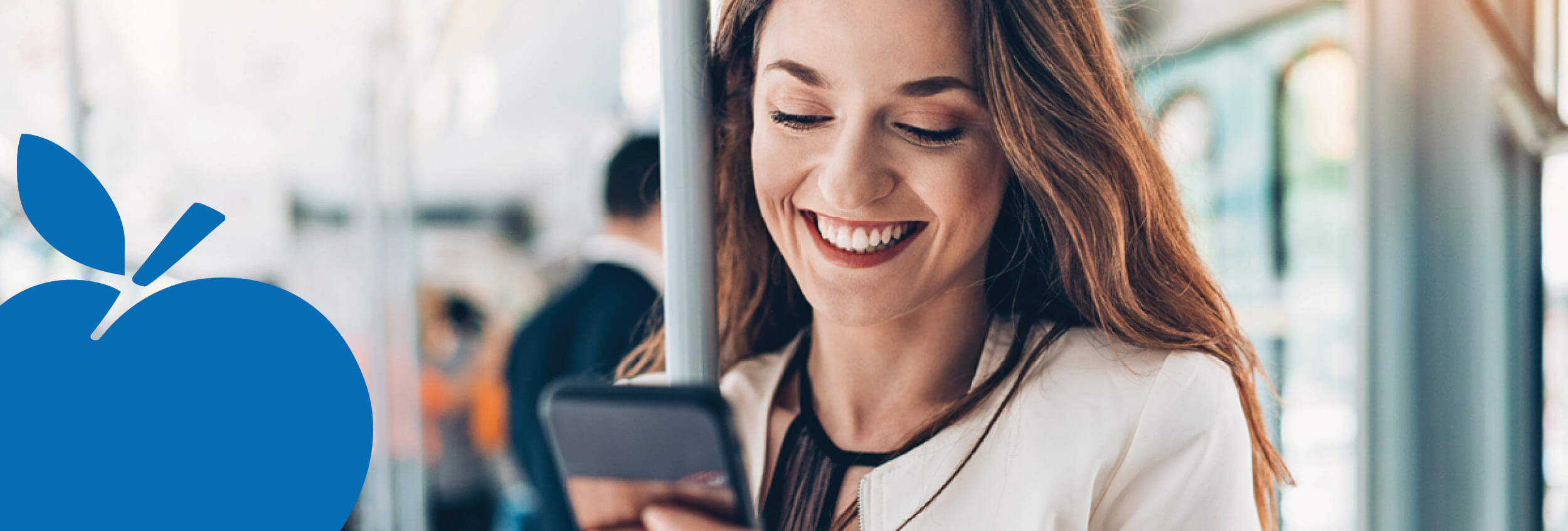 2025 Apple Bank Header Photos8 Smiling train rider listening to smartphone